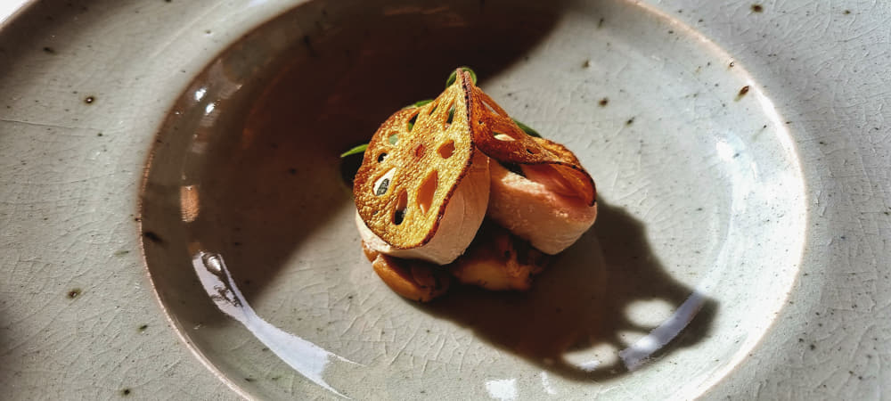 Lotus root and other delicious foods neatly organized on a plate.